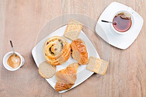 break for two with pastries and small dry cakes accompanied by a cup of coffee and tea