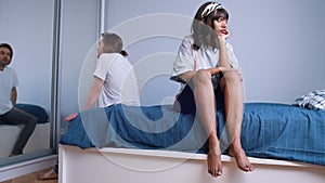 Break up. Young couple having an argument in the bedroom. Reflecting in the big mirror