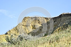 Breakage of the rock. The layers of clay and soil are visible. Clayey place