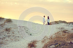 Breakaway to the beach. mature people standing on a sand dune at the beach.