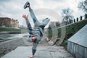 Breakdance performer, upside down motion on street