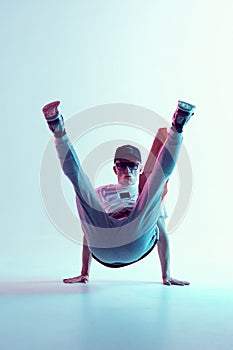 Breakdancer young man stands on hands in neon light. Dance school poster. Battle competition announcement