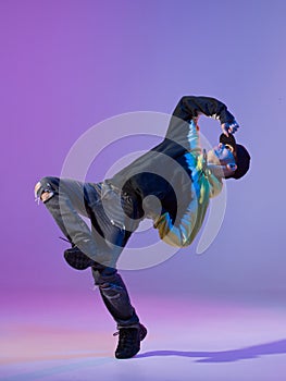 Breakdancing young man in hoodie and baseball cap. Dance school poster. Copy space. Battle competition announcement.