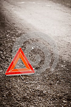 Breakdown of car. Red warning triangle sign on road