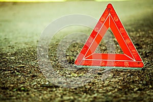 Breakdown of car. Red warning triangle sign on road