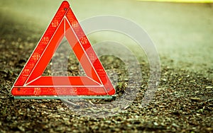 Breakdown of car. Red warning triangle sign on road