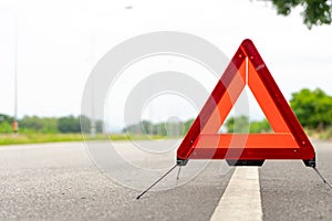 Breakdown triangle stands alongside the road. Car broke down sign on road concept