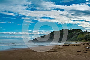 Breakers rolling over vast sand beach. Thick mist over ocean beach on a stormy day. Makorori beach, Gisborne, North