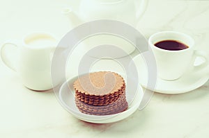 Breakfas: espresso white cup with cookies and milk/Breakfast: espresso white cup with cookies and milk on white table