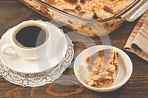 Breakfast with apple pie and a cup of black coffee/breakfast with apple pie and a cup of black coffee on a wooden background