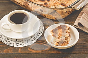 breakfast with apple pie and a cup of black coffee/breakfast with apple pie and a cup of black coffee on a wooden background,