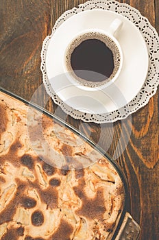 breakfast with apple pie and a cup of black coffee/fresh pie and cup of fragrant black coffee on a wooden table. Top view