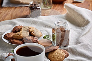 Breakfast background with mug of fresh coffee, homemade oatmeal cookies, grind coffee