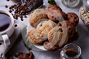 Breakfast background with mug of fresh coffee, homemade oatmeal cookies, grind coffee