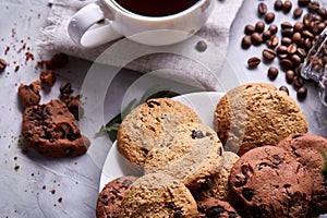 Breakfast background with mug of fresh coffee, homemade oatmeal cookies, grind coffee