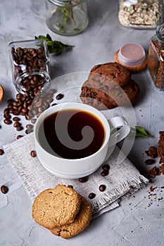 Breakfast background with mug of fresh coffee, homemade oatmeal cookies, grind coffee