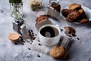 Breakfast background with mug of fresh coffee, homemade oatmeal cookies, grind coffee