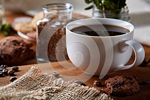 Breakfast background with mug of fresh coffee, homemade oatmeal cookies, grind coffee