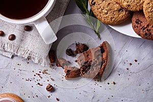 Breakfast background with mug of fresh coffee, homemade oatmeal cookies, grind coffee