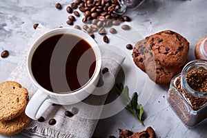 Breakfast background with mug of fresh coffee, homemade oatmeal cookies, grind coffee