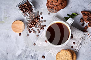 Breakfast background with mug of fresh coffee, homemade oatmeal cookies, grind coffee