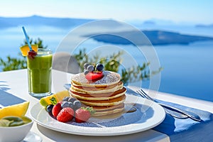 Breakfast on the background of the sea. Kiwi smoothies and sweet pancakes decorated with strawberries and honey