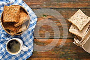 Breakfast background, toast and coffee on rustic wood, top view