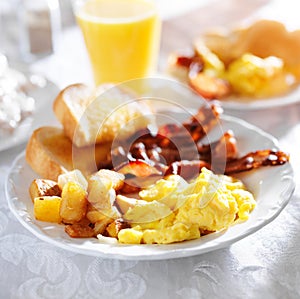 Breakfast with bacon, eggs and home fries photo