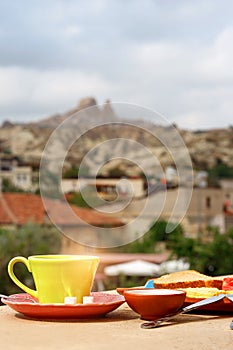 Breakfast on the balcony overlooking Uchisar Mountain in Cappadocia