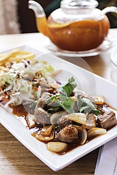 Breakfast with beafsteak, bread, vegetable and tea