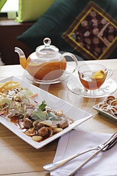 Breakfast with beafsteak, bread, vegetable and tea