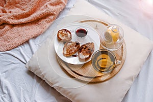 Breakfast in bed. Fried pancakes, tea with lemon. Homeliness .. Lifestyle photo