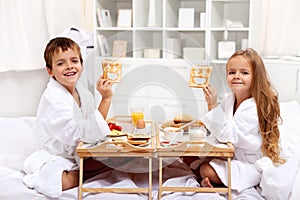 Breakfast in bed with happy kids