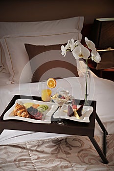 Breakfast in bed at a hotel room