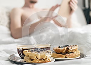 Breakfast in bed. Waffles and coffee on tray