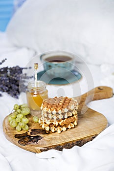 Breakfast with Belgian waffles, apricot jam and coffee