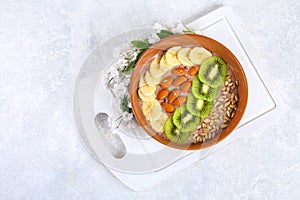 Breakfast berry smoothie bowl topped with bananas, berries, kiwi