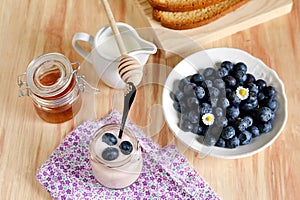 Breakfast with blueberries, honey and yogurt