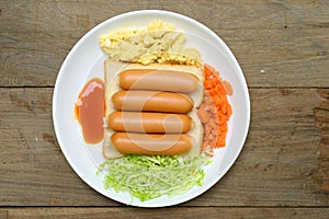 Breakfast with bread egg sausage and vegetables 2