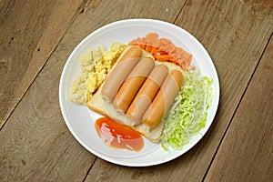 Breakfast with bread egg sausage and vegetables