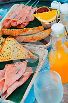 Breakfast with bread, ham, cheese, orange juice