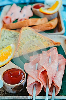 Breakfast with bread, ham, cheese, orange juice