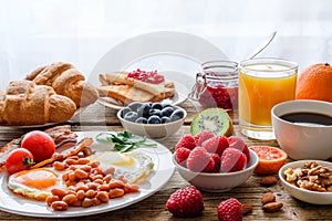 Breakfast buffet. Full english and continental breakfast. Large selection of brunch food on the table with egg, bacon