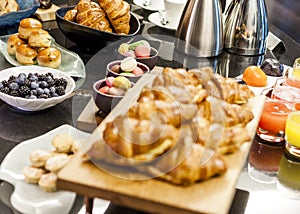 Breakfast buffet table with juice macaroons scones and berries and croissants