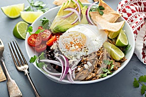 Breakfast burrito bowl with pork carnitas and rice