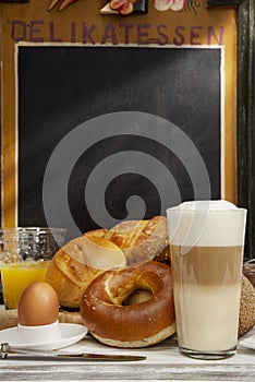 Breakfast in cafe, bread, buns, egg, Latte macchiato, orange juice photo