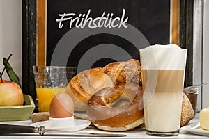 Breakfast in cafe, bread, buns, egg, Latte macchiato, orange juice photo