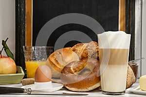 Breakfast in cafe, bread, buns, egg, Latte macchiato, orange juice photo
