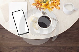 Breakfast in a cafe. Top view, flat lay. Mockup of a modern smartphone with a cup of coffee with cookies