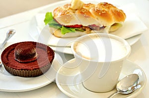 Breakfast with cappuccino and chocolate cake